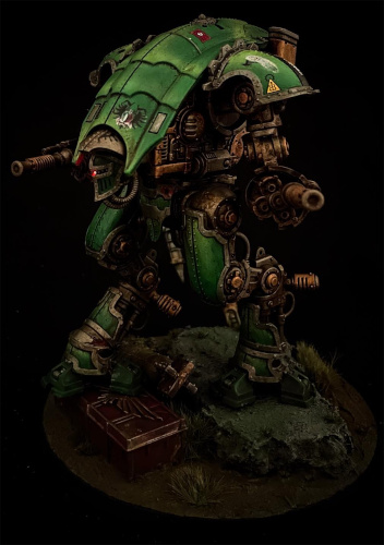 a two legged walking robot with big guns, bright green armour plates, and a weathered rusted look. there is a red eye glowing from inside the helmet looking head.